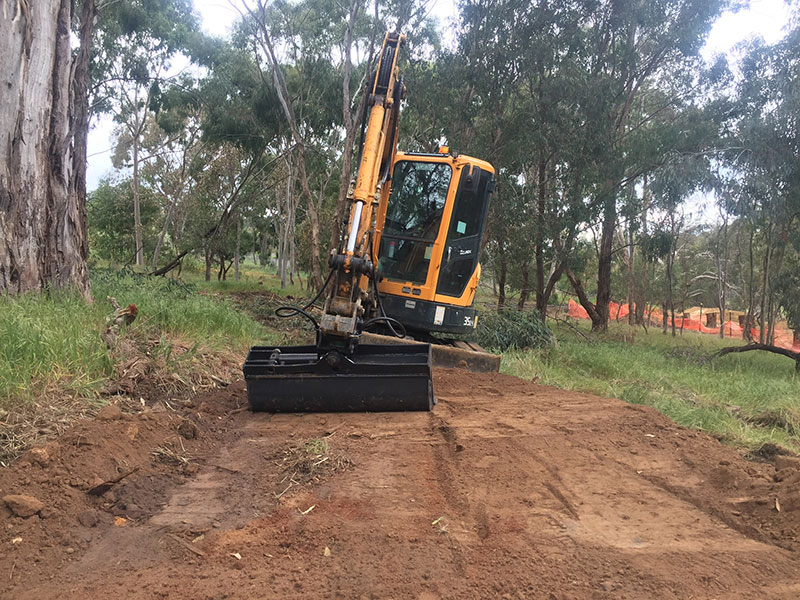 Excavation contractor excavating earth.