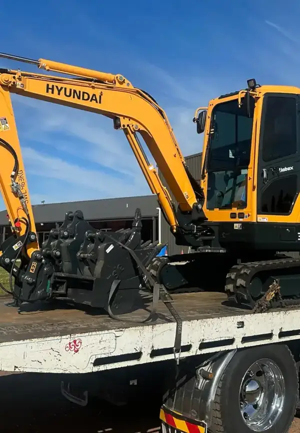 Hyundai excavator loaded on transport truck ready for delivery