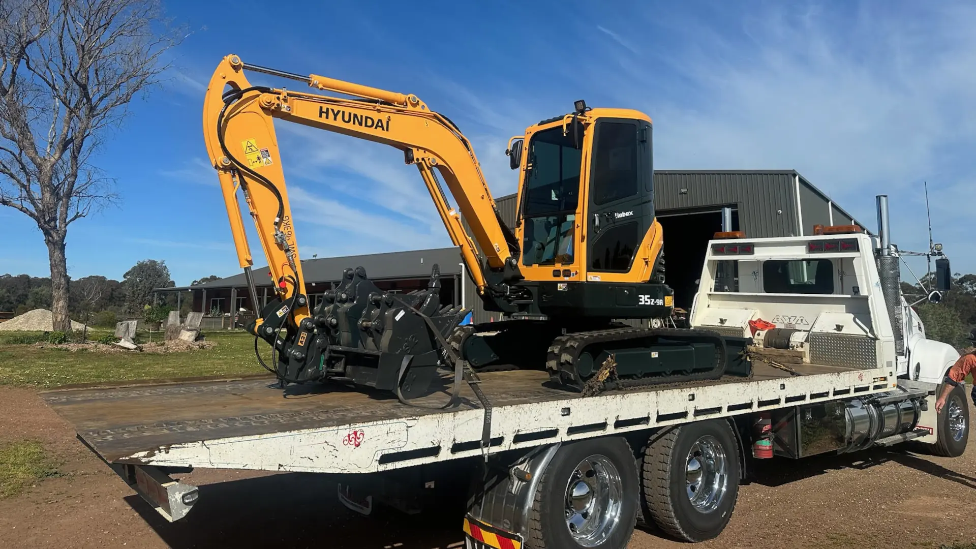 Hyundai excavator loaded on transport truck ready for delivery