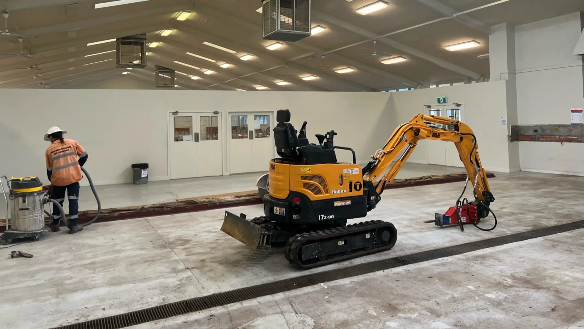 Indoor excavation work site with mini excavator