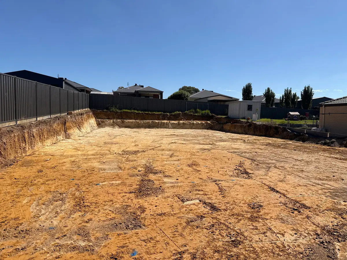 Excavator performing site cuts and levelling